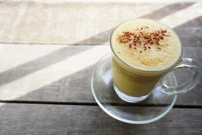 A cup of golden turmeric milk known for the health benefits of turmeric